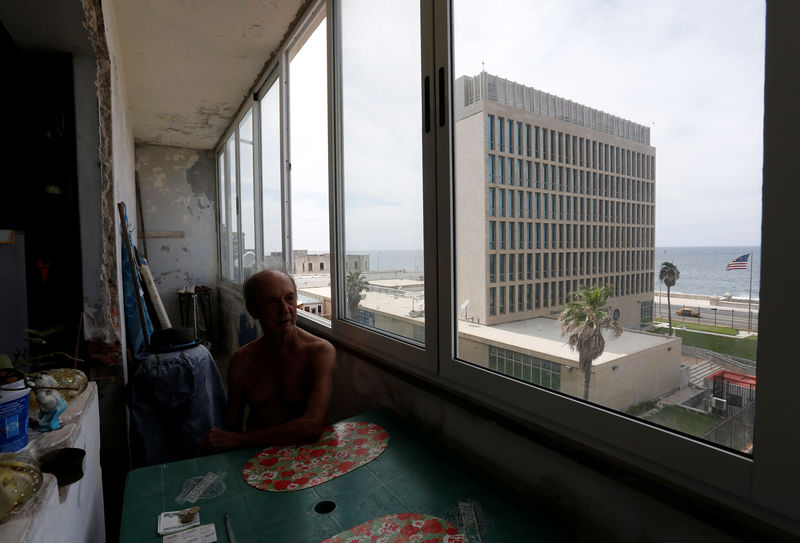 © Reuters. A man sits in his apartment across from the U.S. embassy in Havana