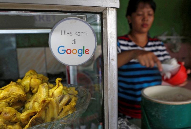 © Reuters. A sticker reading 'Review us on Google' is pictured at a food stall in Jakarta