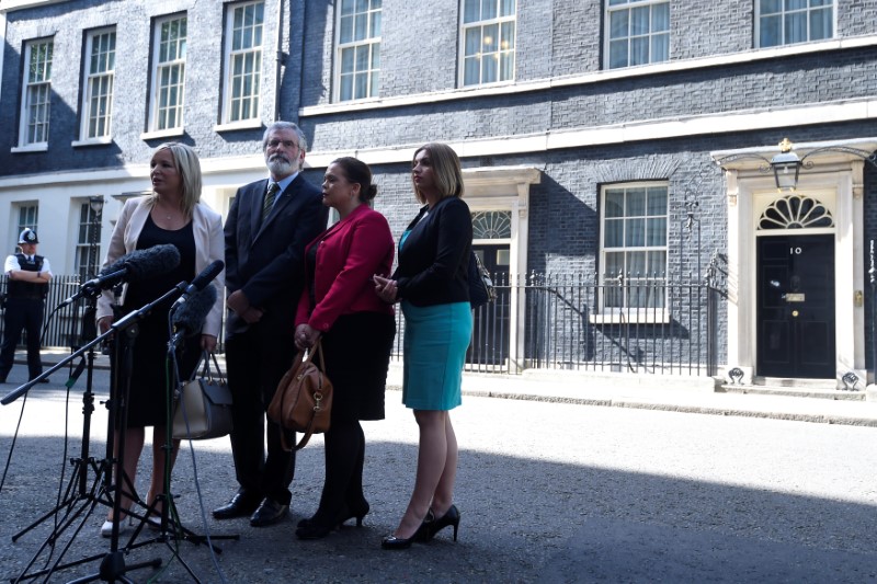 © Reuters. A Sinn Fein delegation, including President, Gerry Adams, and the leader of Sinn Fein in Northern Ireland, Michelle O'Neill, talk to the media outside 10 Downing Street in central London