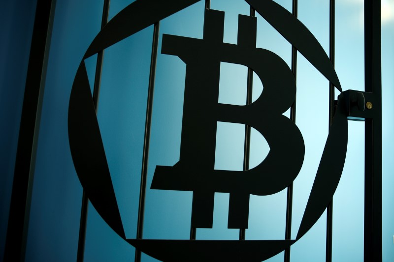 © Reuters. A Bitcoin (virtual currency) logo is pictured on a door at La Maison du Bitcoin in Paris