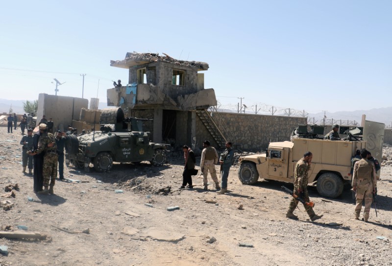 © Reuters. Afghan security forces inspect the aftermath of suicide bomb blast in Paktia Province