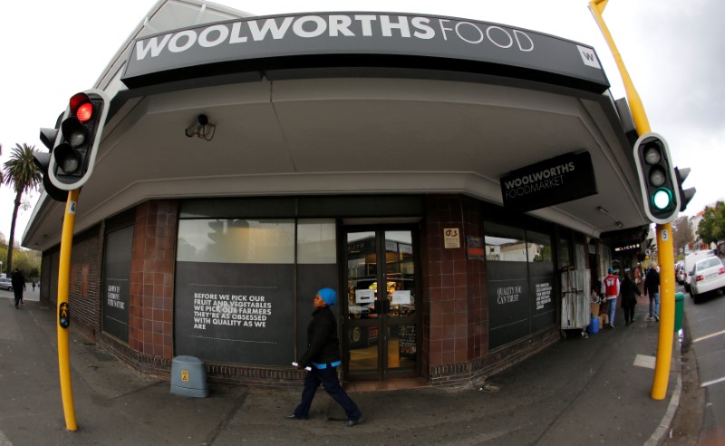 © Reuters. A woman walks past an outlet of retailer Woolworths in Cape Town