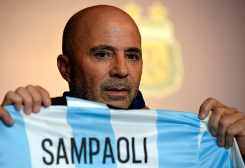 © Reuters. FILE PHOTO - Sampaoli, newly appointed coach of Argentina’s national soccer team holds a jersey with his name on it during his official presentation at the squad's camp in Buenos Aires