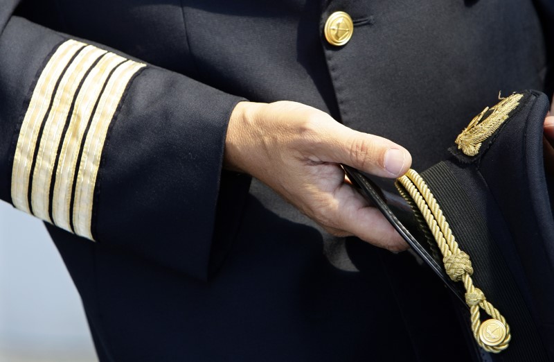 © Reuters. An Alitalia pilot holds his cap at Fiumicino international airport in Rome