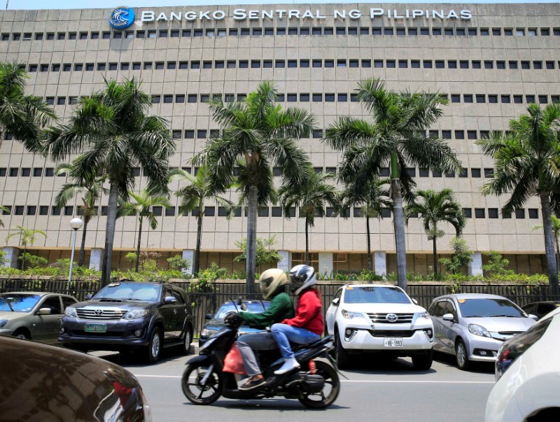 © Reuters. Motorcycle pases a building of the Bangko Sentral ng Pilipinas (Central Bank of the Philippines) in Manila