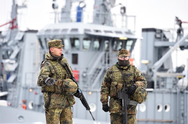 © Reuters. German army Bundeswehr soldiers patrol ahead of a visit of Chancellor Merkel to Naval Base Command in Kiel