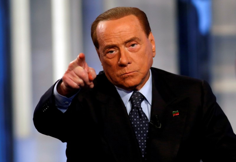 © Reuters. FILE PHOTO: Italy's former Prime Minister Silvio Berlusconi gestures as he attends television talk show "Porta a Porta" (Door to Door) in Rome