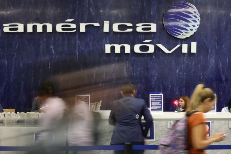 © Reuters. The logo of America Movil is pictured on the wall of a reception area in the company's corporate offices in Mexico City