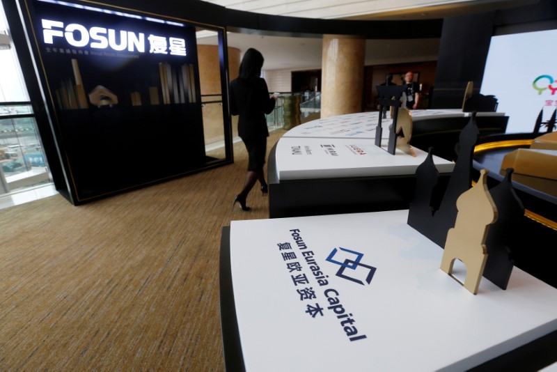 © Reuters. Fosun International Ltd services are displayed at a news conference in Hong Kong