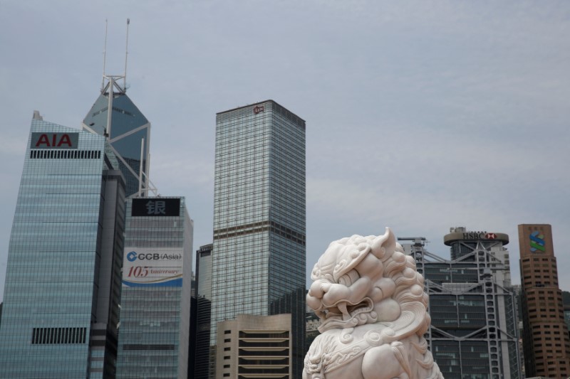 © Reuters. A lion sculpture is seen in front of office towers at the financial Central district in Hong Kong