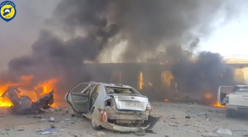 © Reuters. A still image taken from a video uploaded by White Helmets, shows vehicles on fire at the site of a car bomb, said to be in the town of al-Dana