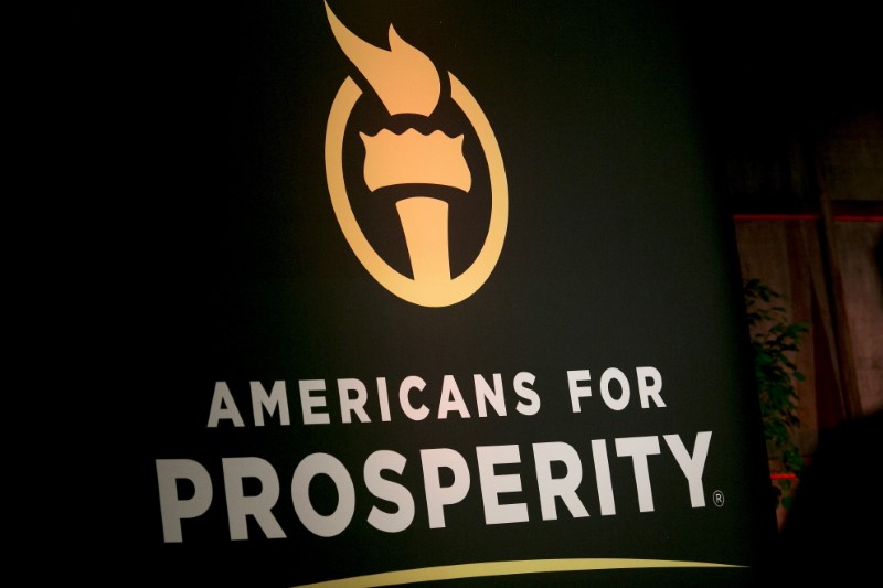 © Reuters. An Americans for Prosperity banner is seen during an event in Manchester