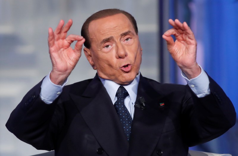 © Reuters. Italy's former PM Berlusconi gestures during the television talk show "Porta a Porta" in Rome