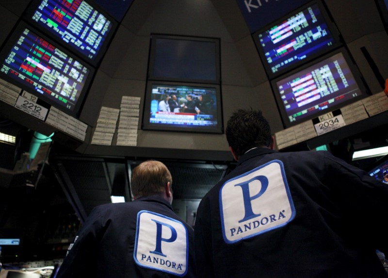 © Reuters. File photo of traders working at the kiosk where Pandora internet radio is traded on the floor of the New York Stock Exchange