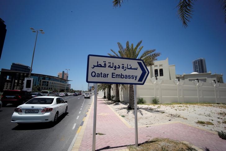 © Reuters. A sign indicating a route to Qatar embassy is seen in Manama