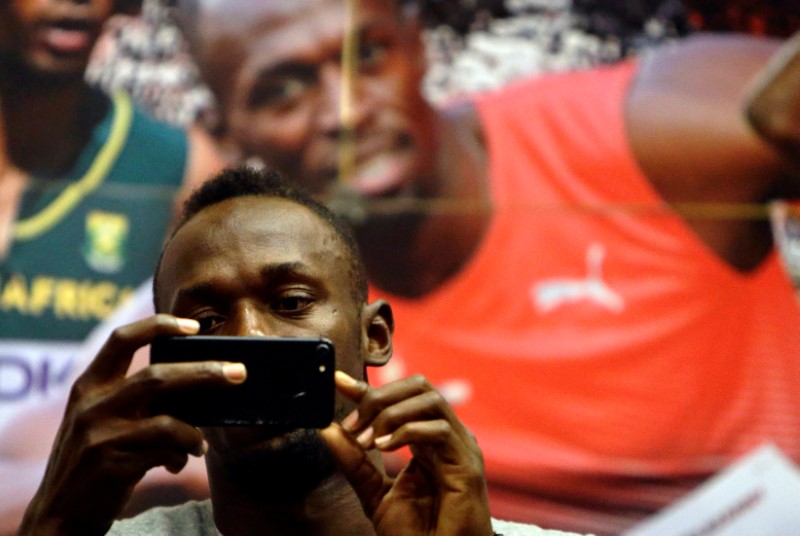 © Reuters. Jamaican sprinter Usain Bolt takes a picture during a news conference before the Ostrava Golden Spike athletics meeting in Ostrava
