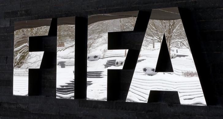 © Reuters. FILE PHOTO: Snow-covered landscape is reflected in a logo in front of FIFA headquarters in Zurich