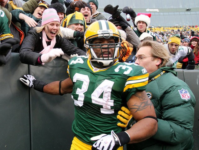 © Reuters. FILE PHOTO: Green Bay Packers running back Green celebrates with fans after a rushing for a touchdown in Wisconsin