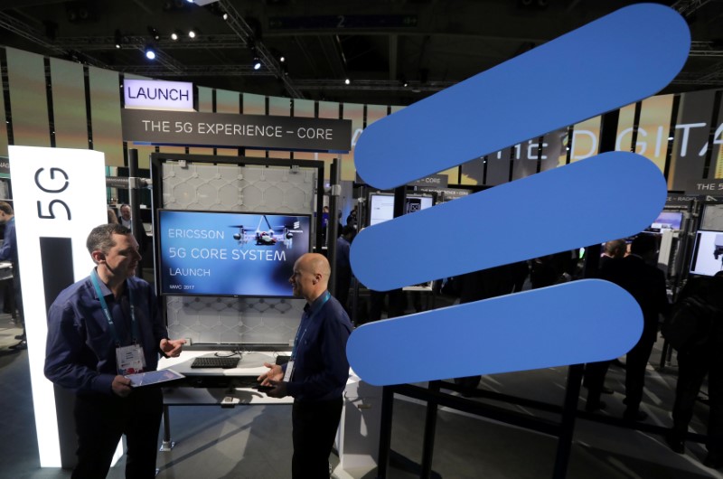 © Reuters. FILE PHOTO: Ericsson's employees stand inside their booth at Mobile World Congress in Barcelona