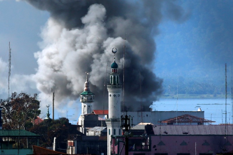 © Reuters. An explosion is seen after a Philippines army aircraft released a bomb during an airstrike in Marawi city