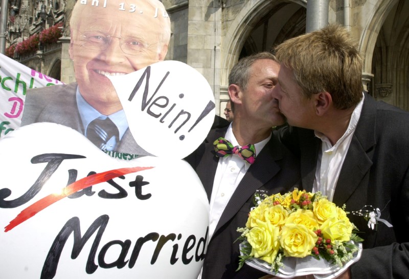 © Reuters. FILE PHOTO: Gay couple Holzapfel and Scattler kiss as they protest at the Marienplatz in Munich