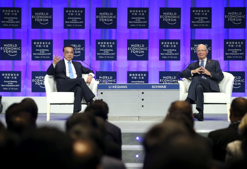 © Reuters. Chinese Premier Li Keqiang and World Economic Forum Founder and Executive Chairman Klaus Schwab attend the World Economic Forum in Dalian