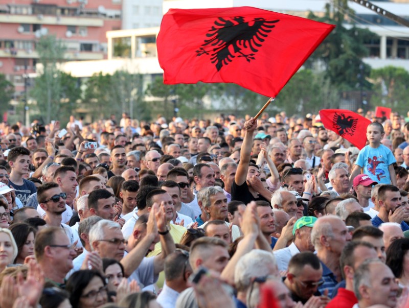 © Reuters. A supporter of the Socialist Party waves his flag during a post-elections rally in Tirana