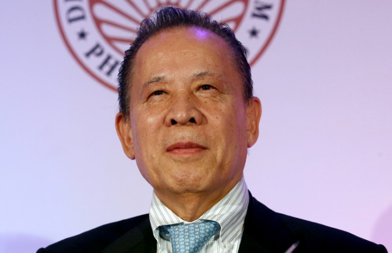 © Reuters. FILE PHOTO: Kazuo Okada, chairman of Tiger Resort, Leisure and Entertainment Inc. listens at the press launch of 65th annual Miss Universe competition