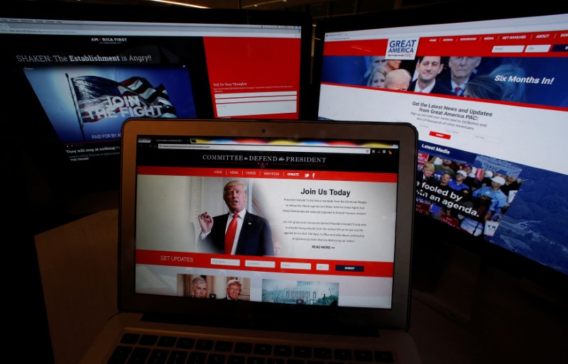 © Reuters. The websites of the three largest Political Action Committee (PAC) groups supporting U.S. President Trump and his agenda are seen on computer screens in Washington