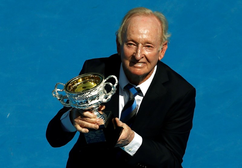 © Reuters. FILE PHOTO: Former Australian tennis player Rod Laver holds a trophy presented to him during a ceremony on Australia Day at the Rod Laver Arena at the Australian Open tennis tournament at Melbourne Park