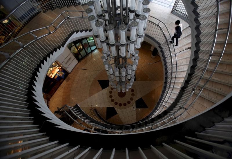 © Reuters. A man walks up a spiral staircase at a shopping mall at the Tokyo's Ginza shopping district, Japan
