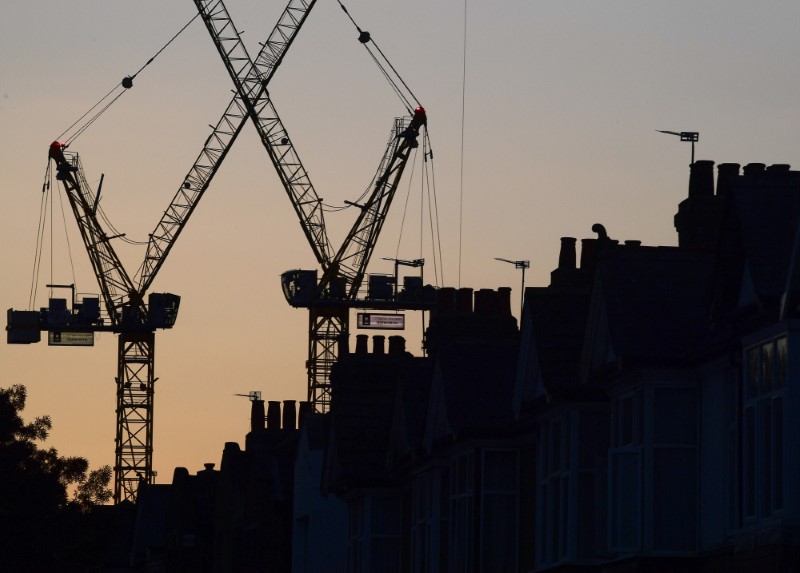 © Reuters. Construction cranes are seen on a residential building project behind homes in west London in Britain in this photograph taken on October 26