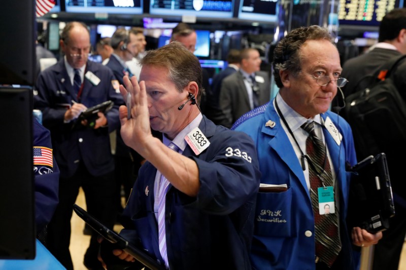 © Reuters. Traders work on the floor of the New York Stock Exchange shortly after the opening bell in New York