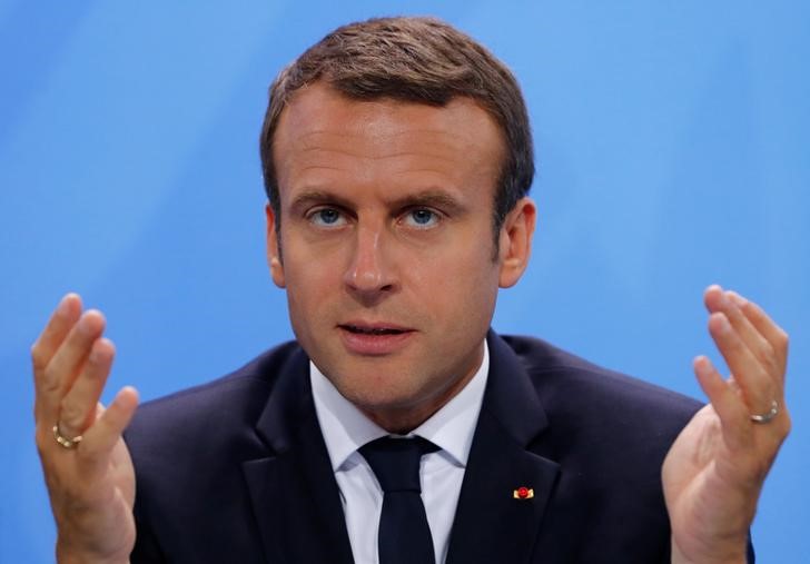 © Reuters. French President Macron gestures during the press conference after the meeting at the Chancellery in Berlin