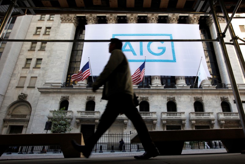 © Reuters. FILE PHOTO: A banner for American International Group Inc hangs on the facade of the New York Stock Exchange