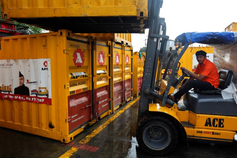 © Reuters. A forklift operator stacks containers at the godown of Agarwal Packers and Movers Ltd. on the outskirts of Mumbai