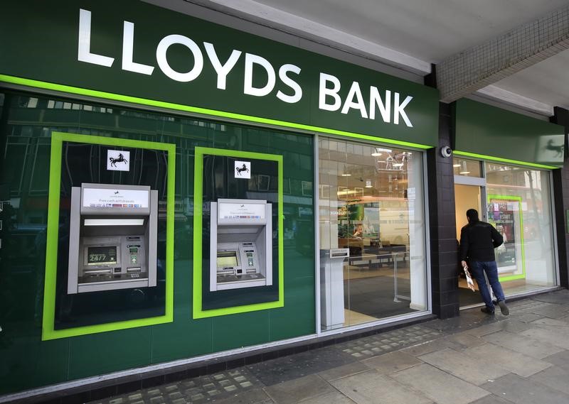 © Reuters. A man enters a Lloyds Bank branch in central London