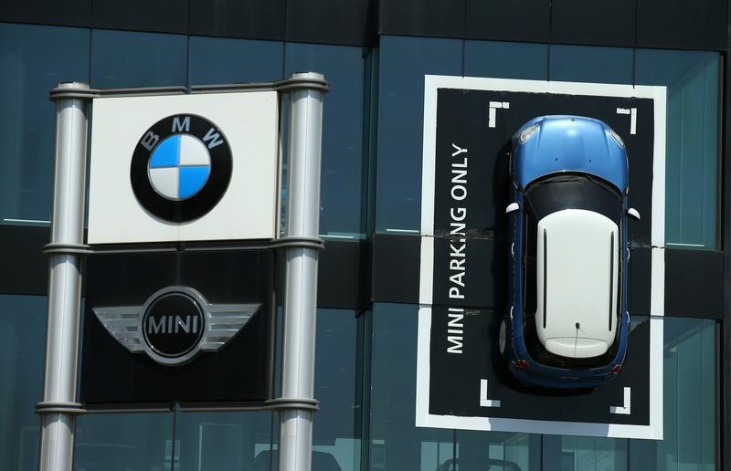 © Reuters. A Mini car is fixed onto a wall at a BMW and Mini dealership in Barcelona