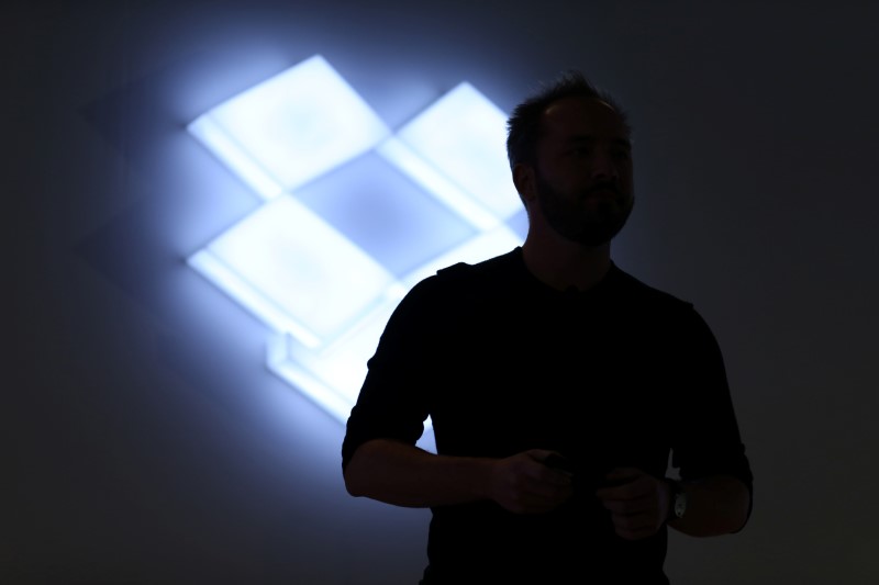 © Reuters. Drew Houston, Chief Executive Officer and founder of Dropbox, stands in front of the company's logo at an announcement event in San Francisco
