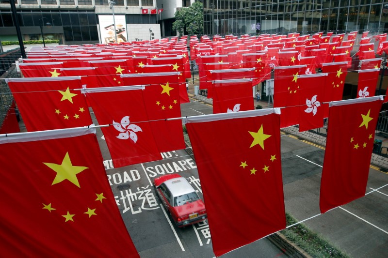 © Reuters. Chinese and Hong Kong flags are seen after celebrations commemorating the 20th anniversary of Hong Kong's handover to Chinese sovereignty from British rule, in Hong Kong