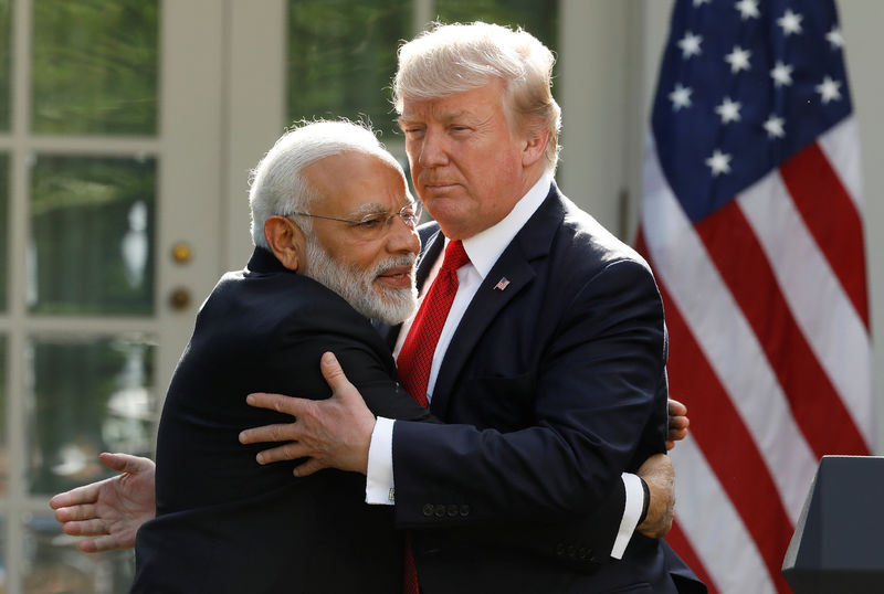 © Reuters. India's Prime Minister Modi hugs U.S. President Trump as they give joint statements in the Rose Garden of the White House in Washington
