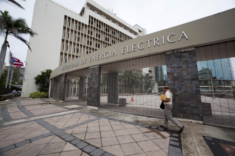 © Reuters. A man walks past the headquarters of Puerto Rican power utility PREPA (also known as AEE) in San Juan