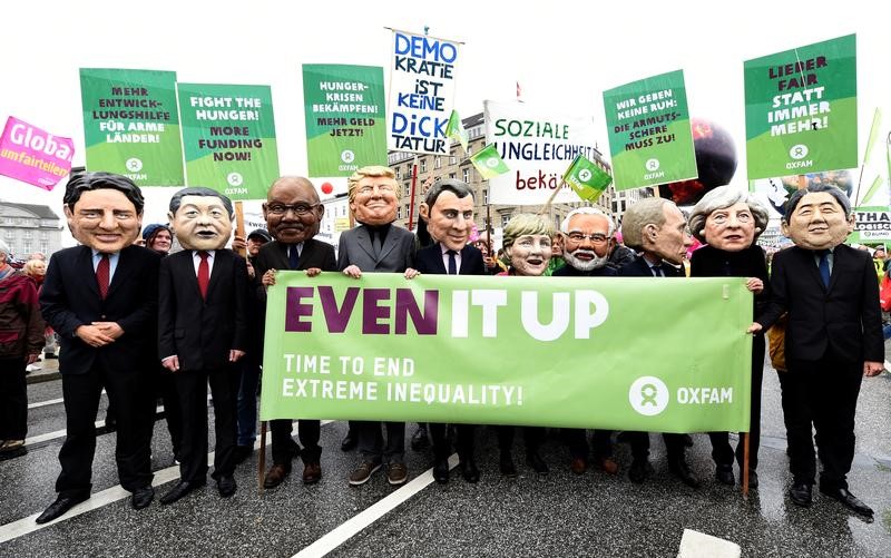 © Reuters. Oxfam’s Big Heads depict G20 leaders take part in protests ahead of the upcoming G20 summit in Hamburg