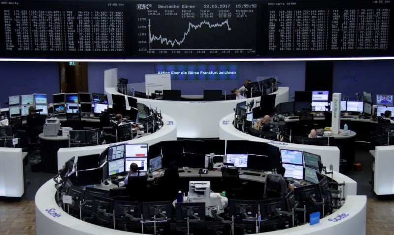 © Reuters. Traders work in front of the German share price index, DAX board, at the stock exchange in Frankfurt