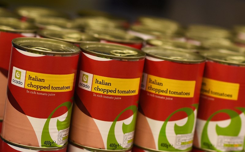 © Reuters. Tins of Ocado own brand chopped tomatoes are seen inside the Ocado Customer Fulfilment Centre in Hatfield