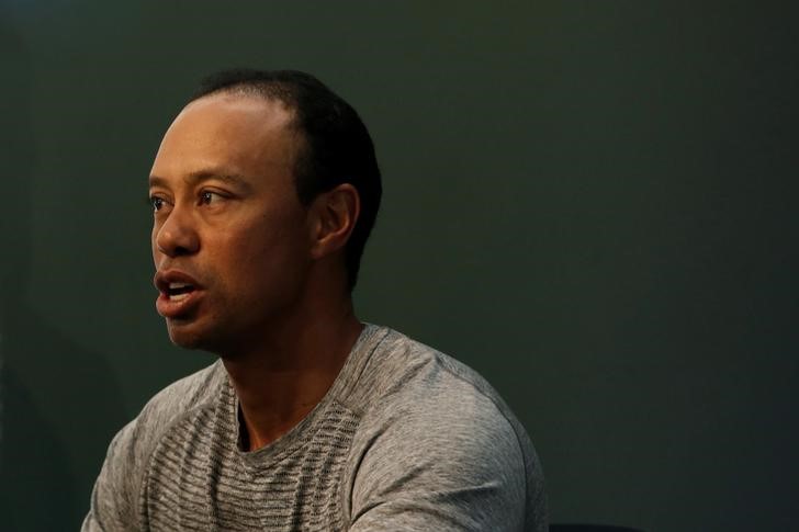 © Reuters. FILE PHOTO - Golfer Tiger Woods speaks as he sits down to sign copies of his new book "The 1997 Masters: My Story" at a book signing event at a Barnes & Noble store in New York