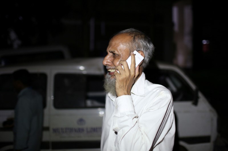 © Reuters. A man cries while talking on the phone following a deadly boiler blast inside a garment factory in Gazipur