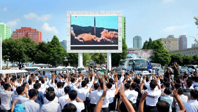 © Reuters. KCNA picture of people watching a huge screen showing the test launch of intercontinental ballistic missile Hwasong-14