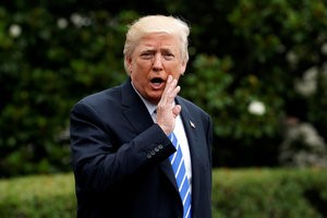 © Reuters. Trump says something to reporters as he departs for travel to Poland in Washington