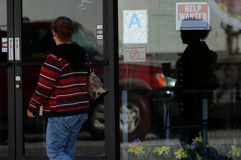 © Reuters. A woman walks past a "help wanted" sign on a restaurant in Los Angeles